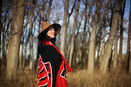 Critically acclaimed Canadian opera singer Marion Newman stands amoungst the trees.