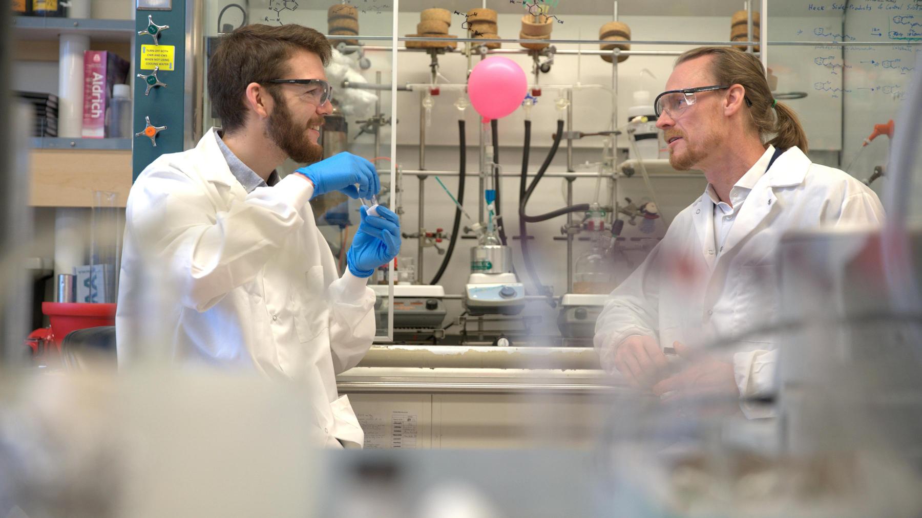 Two graduate students collaborating on work in a university lab.